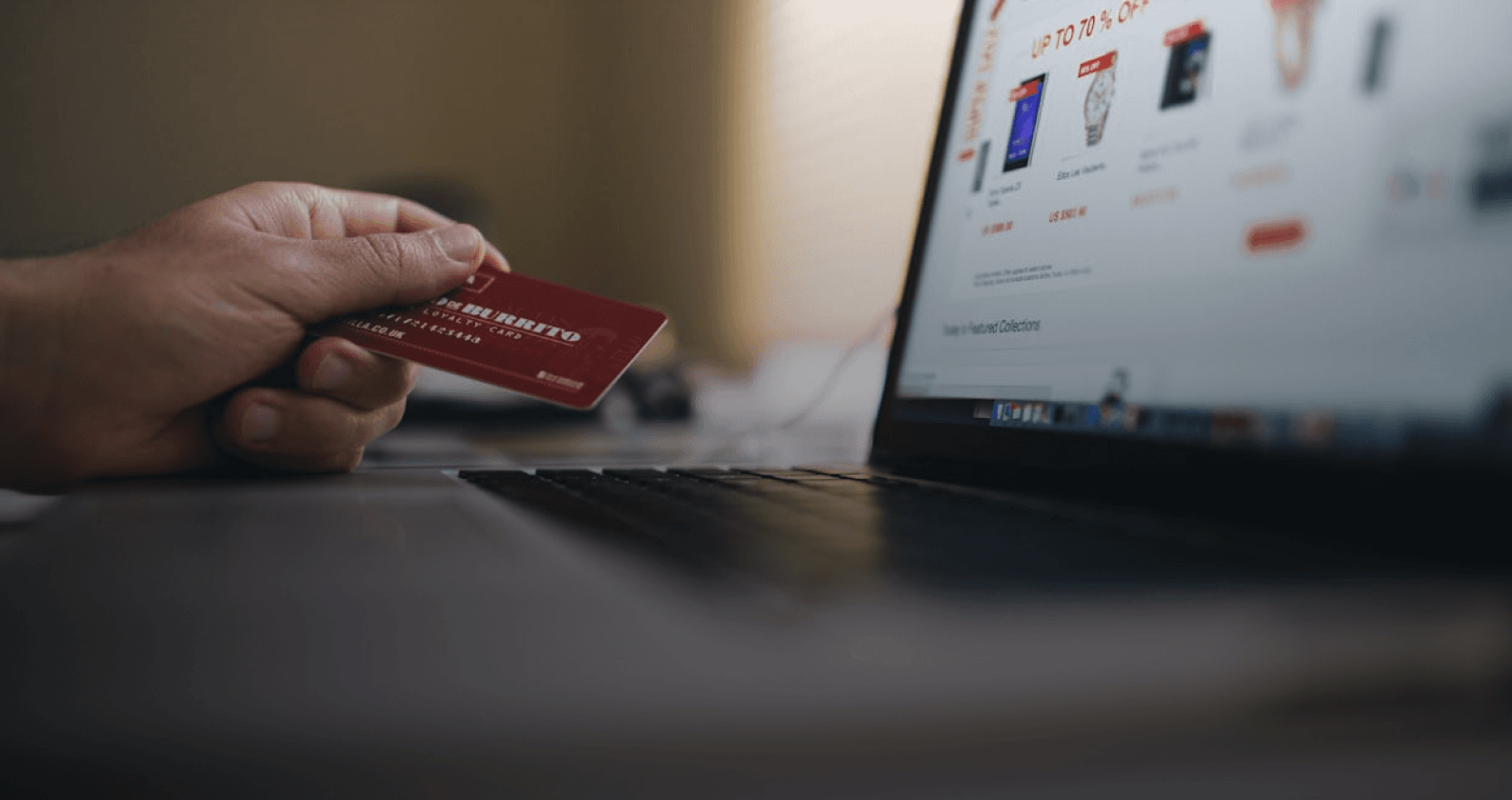 a card before laptop showcasing a shopping website