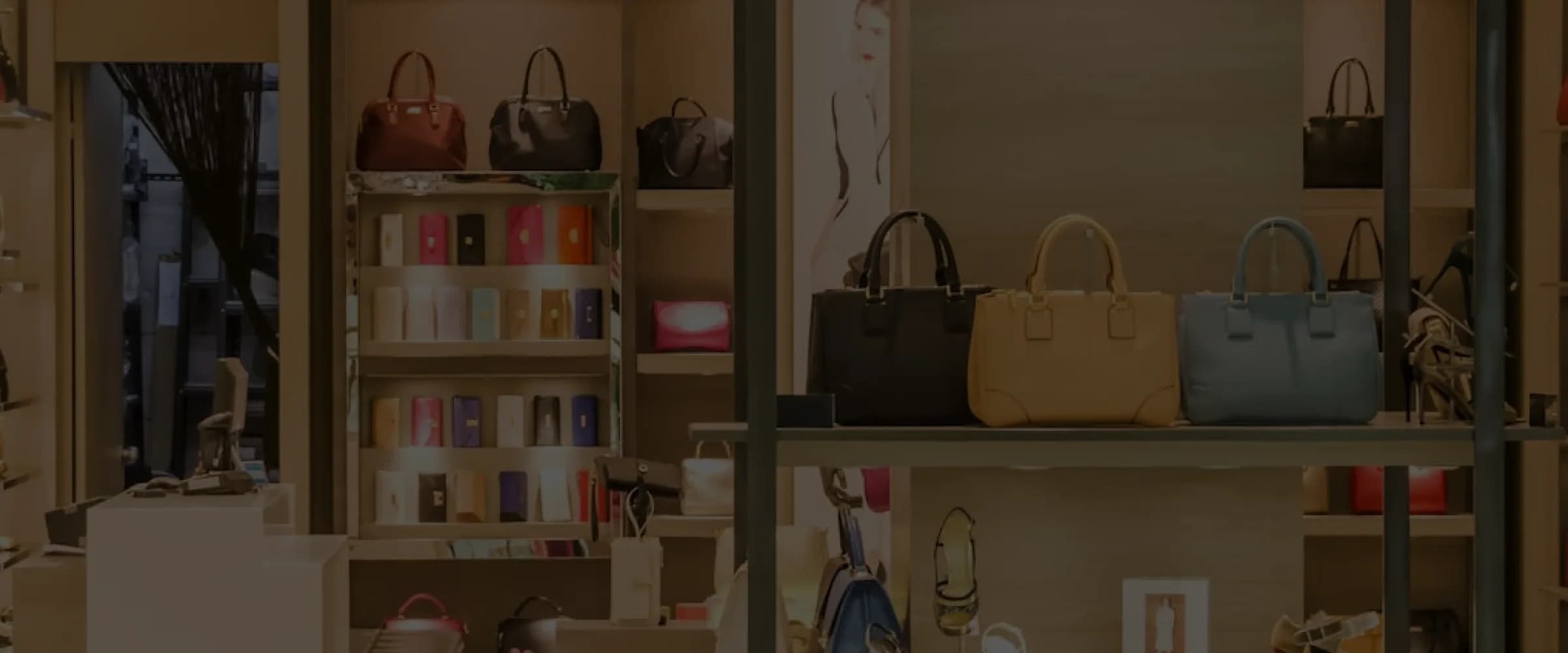 Luxury retail store interior showcasing handbags and accessories on display shelves