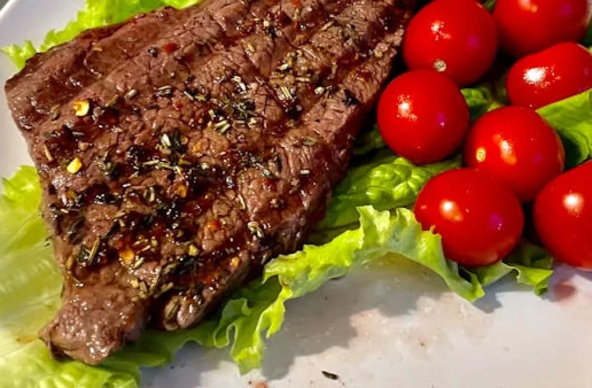 beef steak served with tomatoes and lettuce